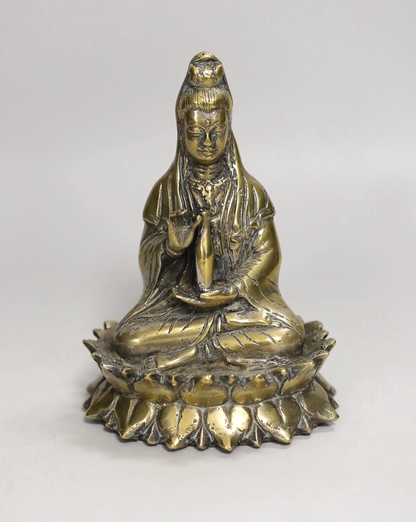 A Chinese bronze seated figure of Guanyin, 13cm